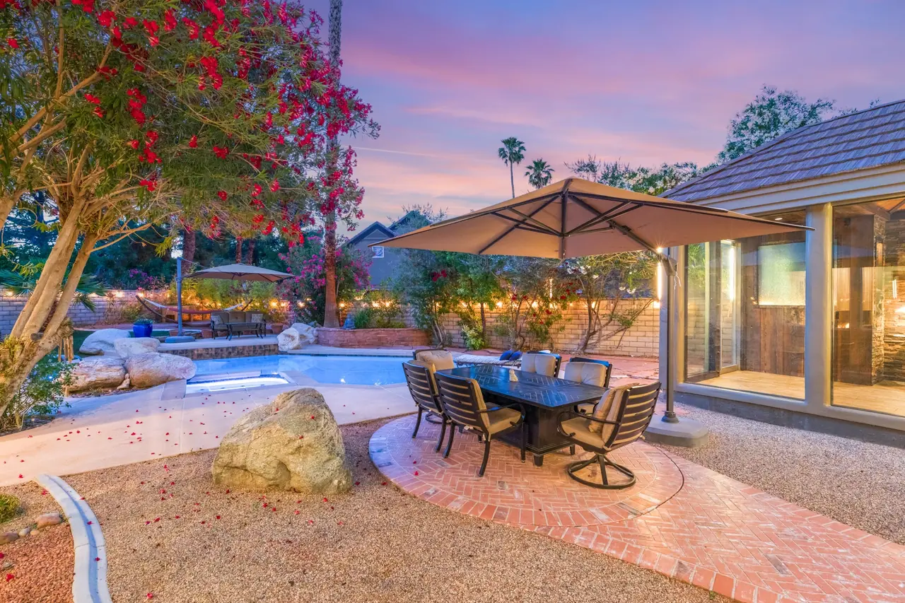 Outdoor dining under a shade umbrella at dusk