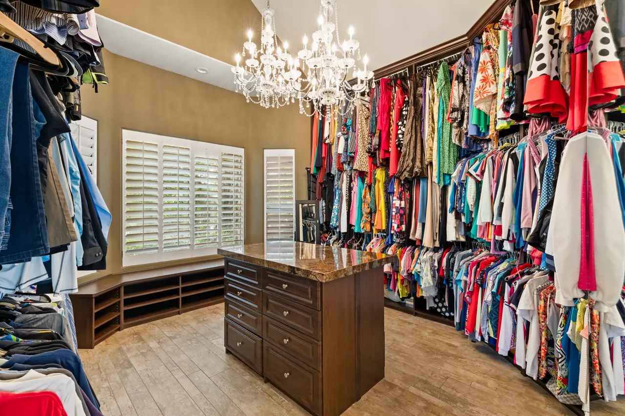 Primary closet with chandeliers