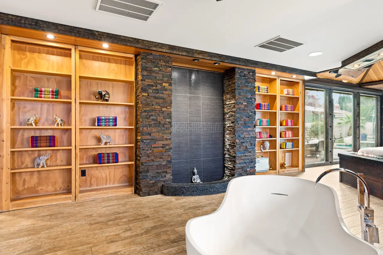 Primary retreat with built-ins and indoor waterfall